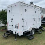 image shows a luxury portable restroom trailer, possibly from Carolina Restroom or a similar rental service